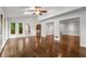 Open-concept living room with hardwood floors and access to the outdoor deck at 355 Highlands Trce, Roswell, GA 30075