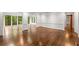 Spacious living room with access to sunroom with walls of windows and hardwood floors at 355 Highlands Trce, Roswell, GA 30075
