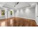 Spacious main bedroom features hardwood floors, tray ceiling, recessed lighting, and natural light at 355 Highlands Trce, Roswell, GA 30075