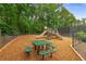 Community playground with slides, picnic table, and swing set offers outdoor fun at 355 Highlands Trce, Roswell, GA 30075