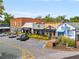 A view of a street with storefronts, sidewalks, and parking spaces available for visitors at 355 Highlands Trce, Roswell, GA 30075