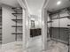 Custom walk-in closet leads to a gorgeous double-vanity bathroom at 355 Highlands Trce, Roswell, GA 30075