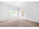 Bedroom featuring a window, neutral carpet, and an attached bathroom at 576 Cliftwood Ct, Sandy Springs, GA 30328