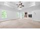 Bright primary bedroom featuring a trey ceiling, ceiling fan, fireplace, and views of the surrounding greenery at 576 Cliftwood Ct, Sandy Springs, GA 30328
