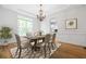 Bright dining room features a chandelier, tray ceiling, and large window for natural light at 576 Cliftwood Ct, Sandy Springs, GA 30328