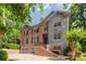 Stately brick home with stone accents, mature trees, and a two-car garage at 576 Cliftwood Ct, Sandy Springs, GA 30328