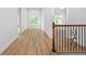 Hallway showcasing hardwood floors and a decorative window providing natural light at 576 Cliftwood Ct, Sandy Springs, GA 30328