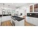 Modern kitchen boasts granite countertops, stainless steel appliances, and open layout to living area at 576 Cliftwood Ct, Sandy Springs, GA 30328