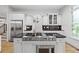 Gourmet kitchen featuring stainless steel appliances, granite countertops, and white cabinetry at 576 Cliftwood Ct, Sandy Springs, GA 30328