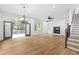 Open-concept living room featuring beautiful hardwood floors, stairs, and a view to the deck at 576 Cliftwood Ct, Sandy Springs, GA 30328