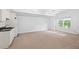 Finished basement with a kitchenette, window, and neutral carpeting at 576 Cliftwood Ct, Sandy Springs, GA 30328