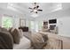 A spacious bedroom with a ceiling fan, large windows, and a cozy sitting area at 576 Cliftwood Ct, Sandy Springs, GA 30328