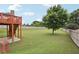 Expansive backyard features lush green grass and a mature tree, perfect for outdoor activities and relaxation at 112 Tara Blvd, Loganville, GA 30052