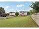 Large backyard bordered by a wooden fence, with lush green grass offering ample space for recreation and relaxation at 112 Tara Blvd, Loganville, GA 30052