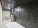 Unfinished basement features water heater, exposed ceiling, and concrete wall at 112 Tara Blvd, Loganville, GA 30052