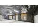 Spacious unfinished basement features large windows, concrete walls, and black wrapped ceiling at 112 Tara Blvd, Loganville, GA 30052
