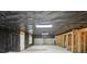 Large unfinished basement with door, windows, concrete walls, and wood framing at 112 Tara Blvd, Loganville, GA 30052