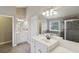 Bathroom features a double vanity, large mirror, and a shower with a glass door at 112 Tara Blvd, Loganville, GA 30052