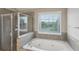 Bright bathroom with a jacuzzi tub and a glass enclosed shower at 112 Tara Blvd, Loganville, GA 30052