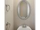 Half-bathroom featuring a sink with a brushed nickel faucet and framed oval mirror at 112 Tara Blvd, Loganville, GA 30052
