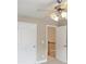 Bedroom with ceiling fan and open door to a hallway with a staircase at 112 Tara Blvd, Loganville, GA 30052