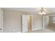 Spacious bedroom featuring a ceiling fan, neutral paint, and doorway to another room at 112 Tara Blvd, Loganville, GA 30052
