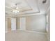Large bedroom with neutral walls, tray ceilings, and natural light at 112 Tara Blvd, Loganville, GA 30052
