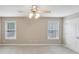 Bedroom featuring a ceiling fan, plush carpet, and bright windows at 112 Tara Blvd, Loganville, GA 30052