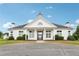 Elegant white clubhouse with black accents, featuring a striking facade and manicured landscaping at 112 Tara Blvd, Loganville, GA 30052