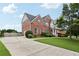 Brick home with a long driveway and well manicured lawn at 112 Tara Blvd, Loganville, GA 30052