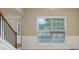 Entryway features staircase, wainscotting, and large window for natural light at 112 Tara Blvd, Loganville, GA 30052