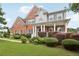 Lovely brick home featuring a well-manicured yard and inviting front porch with columns at 112 Tara Blvd, Loganville, GA 30052