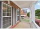 Inviting front porch features brick walls and a view of a beautifully landscaped yard at 112 Tara Blvd, Loganville, GA 30052