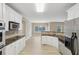 Well-lit kitchen showcases stainless appliances and overlooks the spacious dining area at 112 Tara Blvd, Loganville, GA 30052
