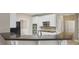 Updated kitchen boasts white cabinets, stainless steel appliances and stone backsplash at 112 Tara Blvd, Loganville, GA 30052