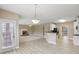 Open living area with fireplace, light-colored walls, hardwood floor, and modern light fixture at 112 Tara Blvd, Loganville, GA 30052