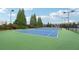 Outdoor tennis court with green and blue surface at 112 Tara Blvd, Loganville, GA 30052
