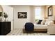 Bright bedroom with a wooden bed frame, bedside lamps, and decorative wall art at 213 Sunshine St, Acworth, GA 30102
