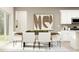 Modern dining room featuring a wooden table, white chairs, and neutral accents at 213 Sunshine St, Acworth, GA 30102