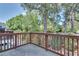 View from an outdoor deck overlooking a lush, green backyard with mature trees at 2325 Limehurst Ne Dr, Atlanta, GA 30319