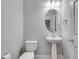 Stylish powder room with pedestal sink, elegant mirror, and modern fixtures at 2325 Limehurst Ne Dr, Atlanta, GA 30319