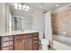 Well-lit bathroom featuring a tiled shower-tub combo, vanity with a large mirror, and neutral tones at 2325 Limehurst Ne Dr, Atlanta, GA 30319