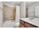 This bathroom features a shower-tub with tan tile surround and vanity with chrome faucet at 2325 Limehurst Ne Dr, Atlanta, GA 30319