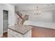 Kitchen island with granite countertop next to dining area and staircase with iron spindles at 2325 Limehurst Ne Dr, Atlanta, GA 30319