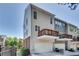 Townhome featuring balconies, an attached garage, and manicured greenery at 2325 Limehurst Ne Dr, Atlanta, GA 30319