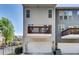Townhouse with a garage and balcony against blue skies and trees at 2325 Limehurst Ne Dr, Atlanta, GA 30319