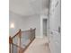 Upstairs hallway showing wooden railing with iron spindles and access to other rooms at 2325 Limehurst Ne Dr, Atlanta, GA 30319