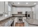 Close-up view of a kitchen featuring granite countertops, stainless steel appliances and a center island at 2325 Limehurst Ne Dr, Atlanta, GA 30319