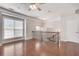 Sun-drenched living room with hardwood floors, large window, and staircase with decorative railing at 2325 Limehurst Ne Dr, Atlanta, GA 30319