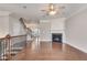 Spacious living room with hardwood floors, fireplace, and staircase with wrought iron railing at 2325 Limehurst Ne Dr, Atlanta, GA 30319